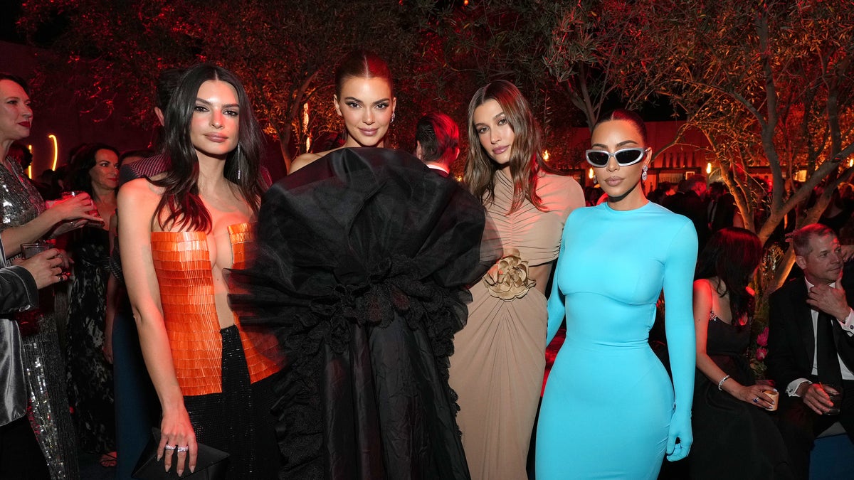 Emily Ratajkowski in red, Kendall Jenner in a long black dress, Hailey Bieber in a brown dress and Kim Kardashian in a long-sleeve Balenciaga dress for the Vanity Fair Oscar Party