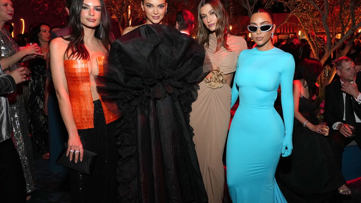 Emily Ratajkowski in red, Kendall Jenner in a long black dress, Hailey Bieber in a brown dress and Kim Kardashian in a long-sleeve Balenciaga dress for the Vanity Fair Oscar Party