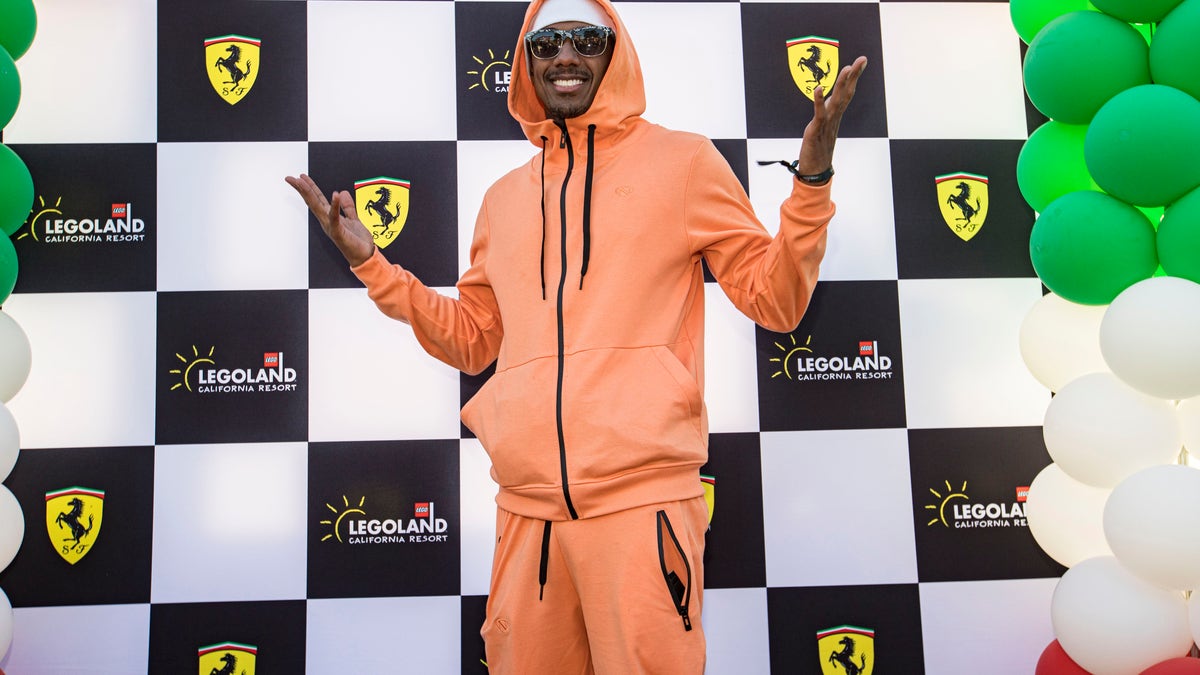 Nick Cannon in an orange matching sweat suit at LEGOLAND