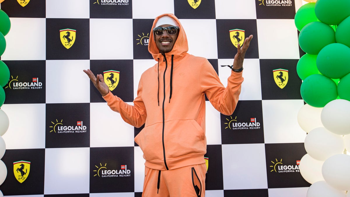 Nick Cannon in an orange matching sweat suit at LEGOLAND