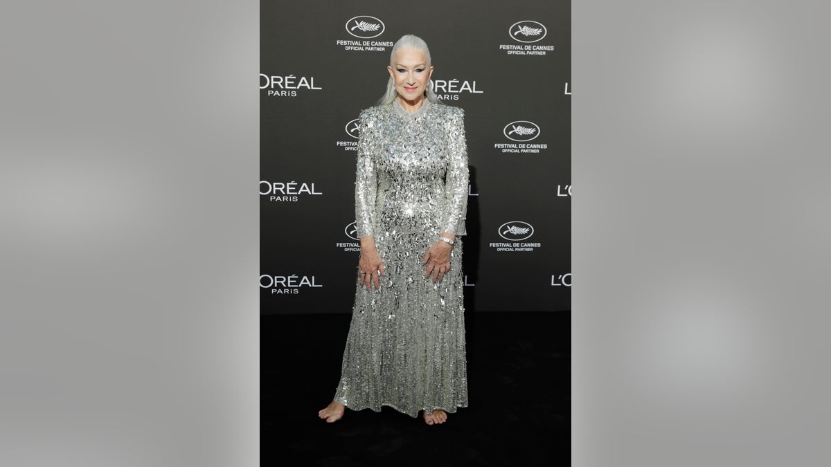 Helen Mirren in a long-sleeve sparkly silver gown at a L'Oreal event