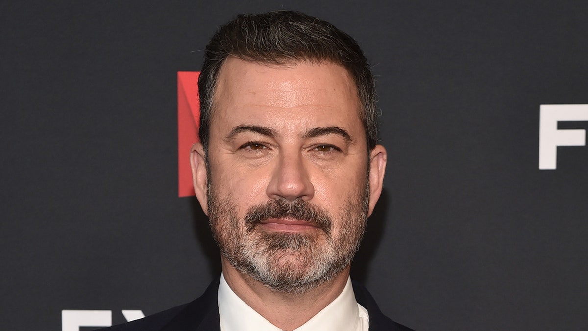 Jimmy Kimmel on red carpet with a serious look