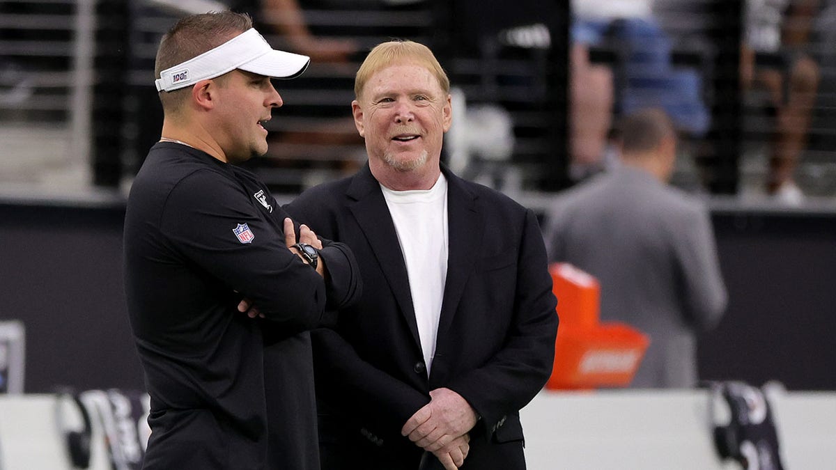 Mark Davis stands with Raiders head coach Josh McDaniels