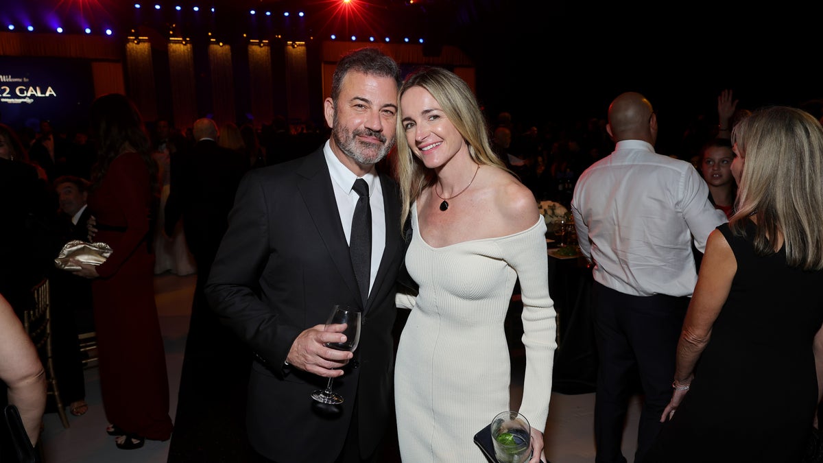 Jimmy Kimmel in a black suit alongside his wife Molly in a cream off-the-shoulder dress