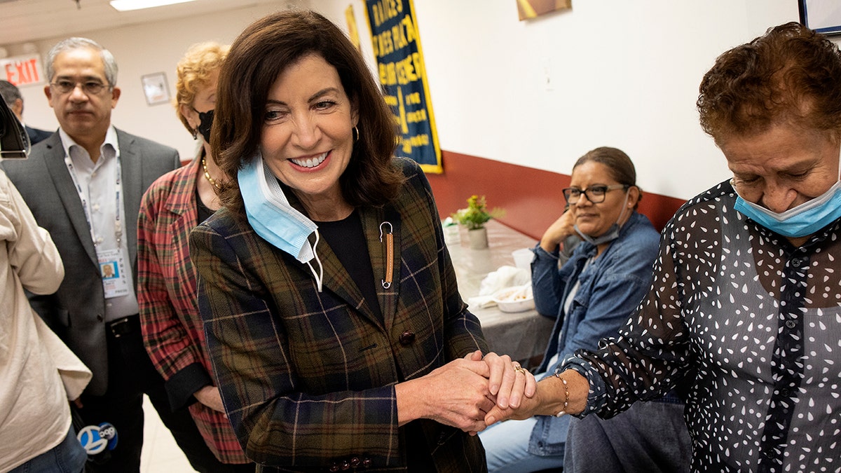 Hochul shakes hands while campaigning at Brooklyn senior center