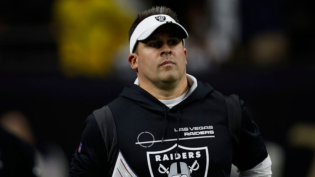 Raiders head coach Josh McDaniels takes the field before the Saints game.