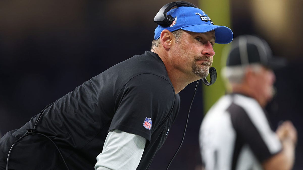 Dan Campbell looks on from the Lions' sideline during a game vs the Dolphins