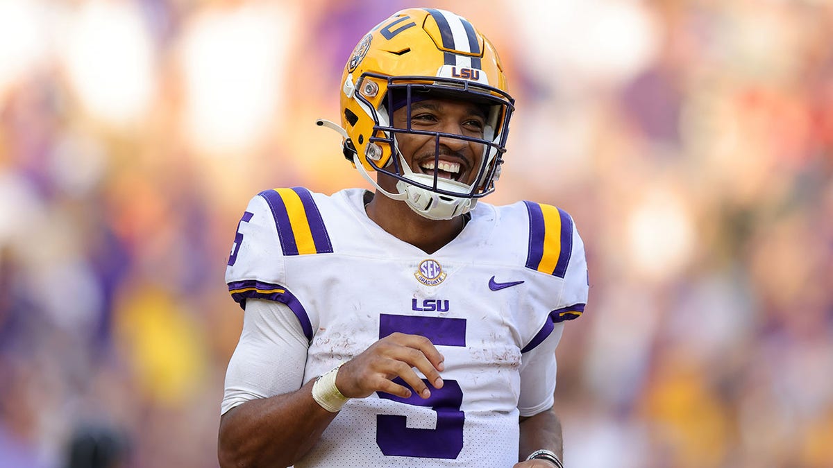 Jayden Daniels celebrates after scoring a touchdown