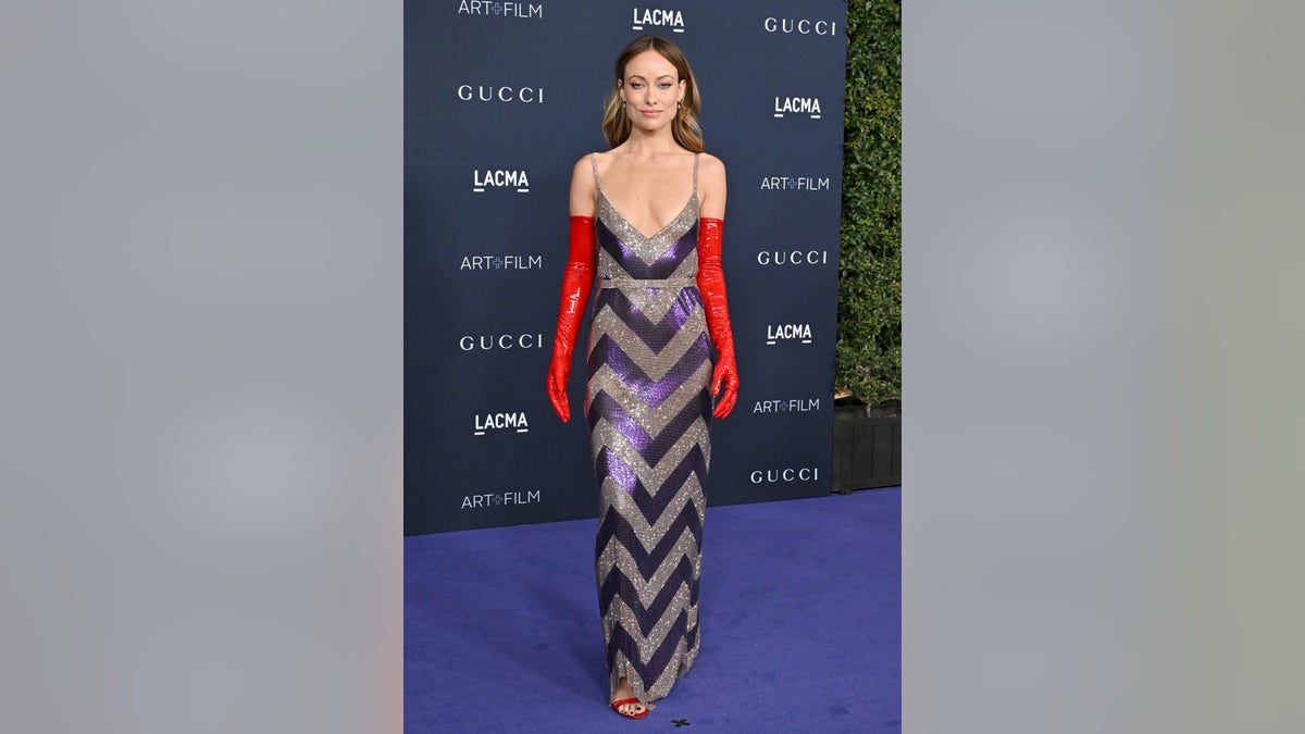 Olivia Wilde wore a chevron dress with elongated red gloves