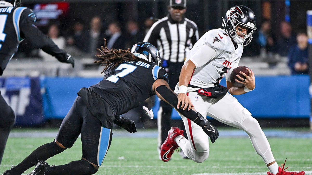 Marcus Mariota gets tackled during Panthers game