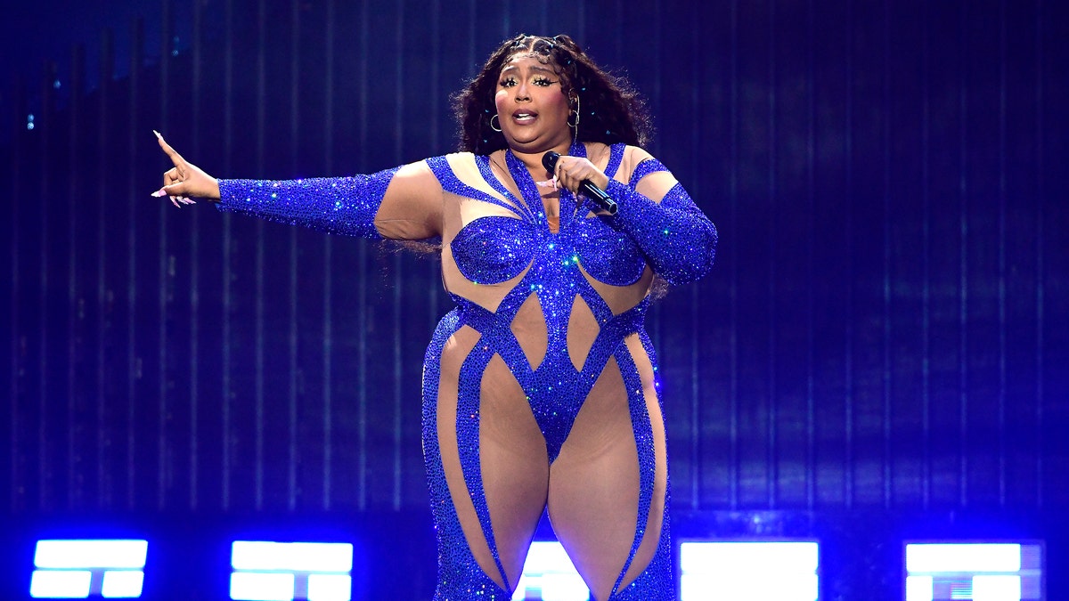Lizzo performs in a cut-out sparkly blue outfit