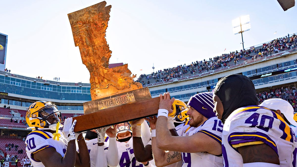 LSU Tigers carry the trophy after beating Arkansas