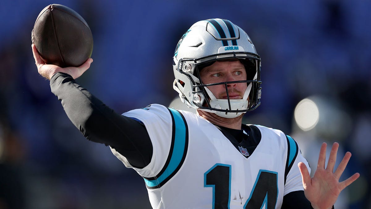 Quarterback Sam Darnold warms up before the Ravens game