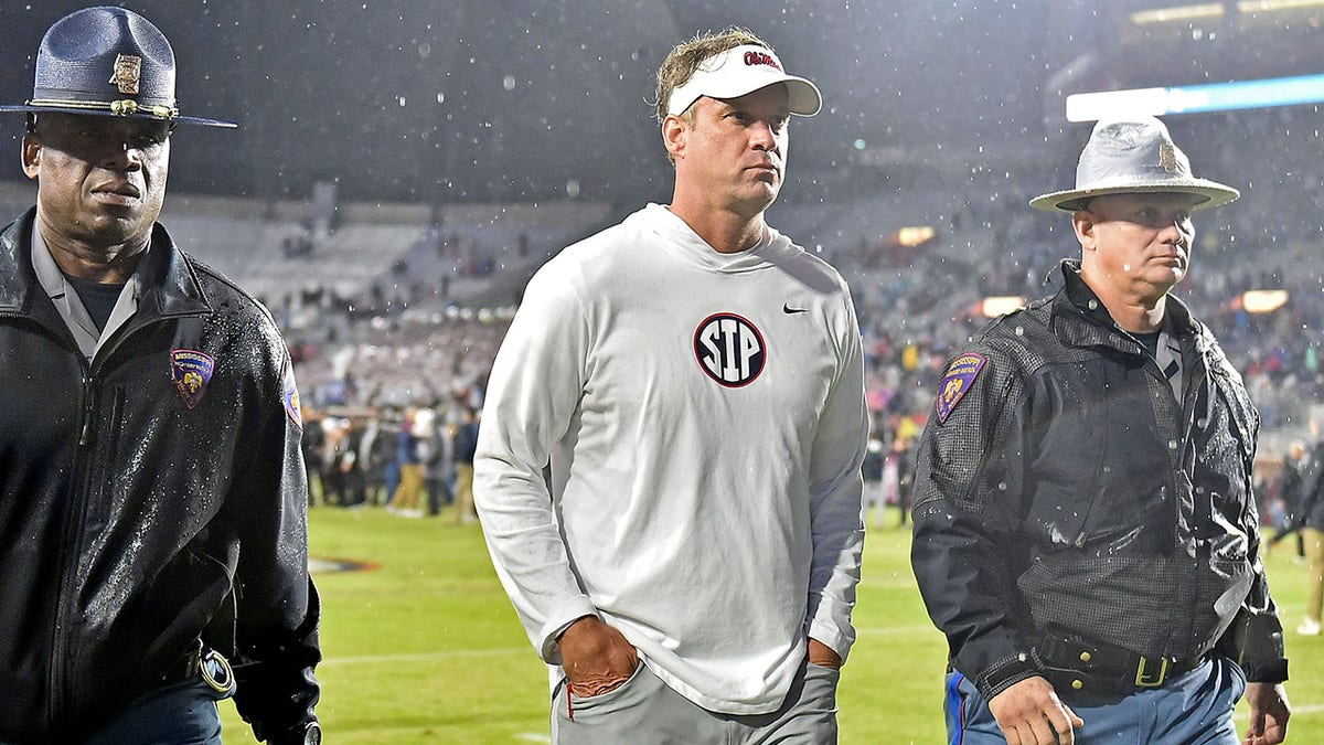 Lane Kiffin walks off the field after losing to Mississippi State