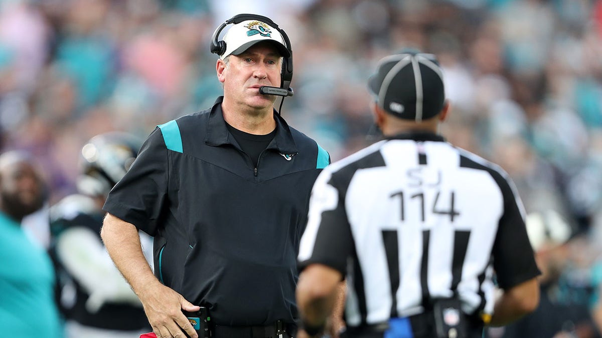 Doug Pederson talks to a game official