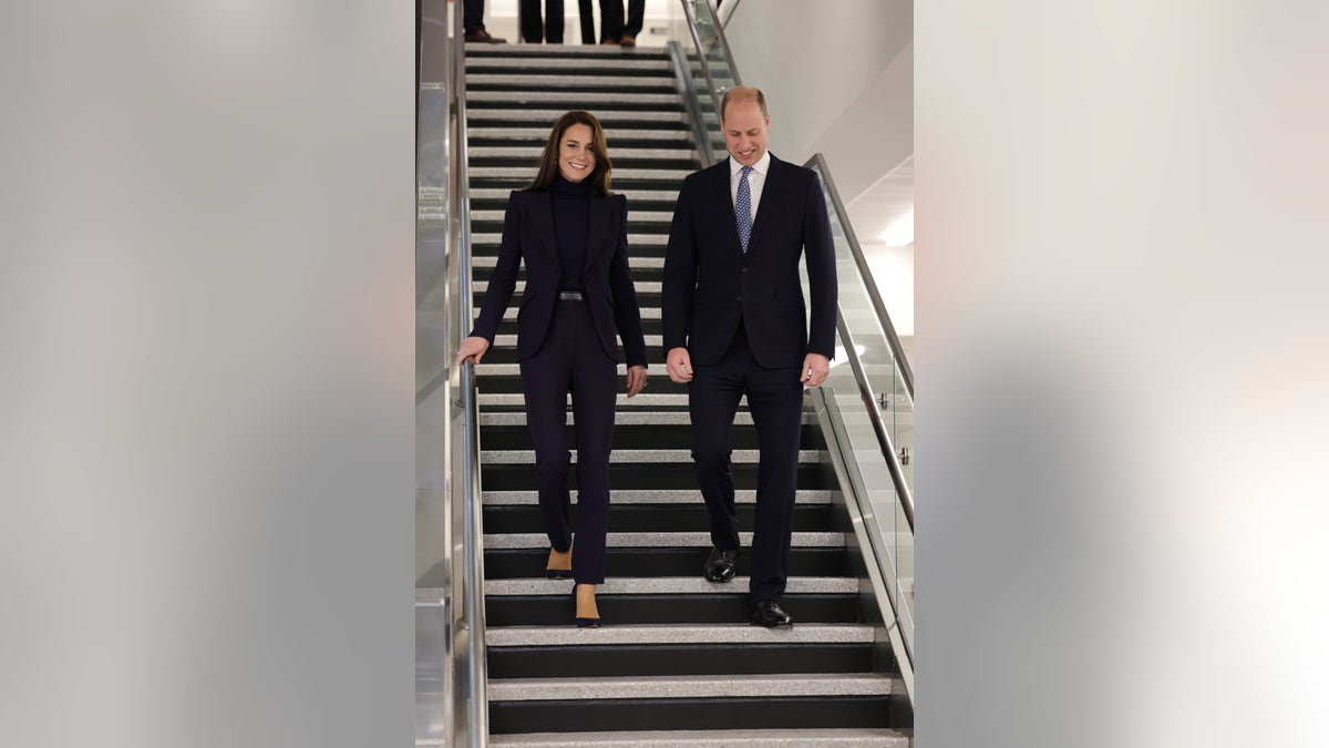 Prince William and Kate Middleton walk down stairs