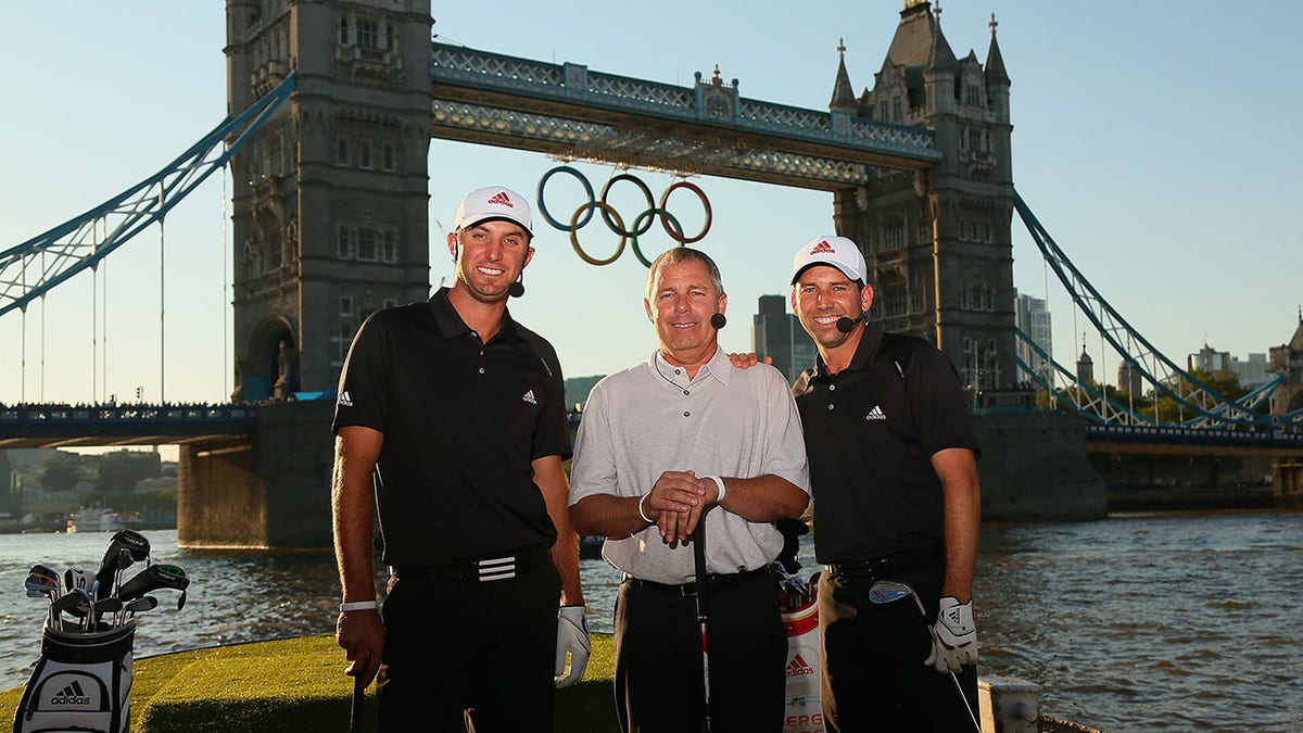 TaylorMade CEO Mark King poses with Dustin Johnson and Sergio Garcia