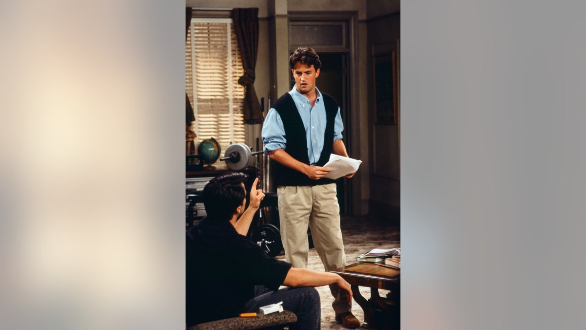 Matthew Perry as Chandler Bing in "Friends" wearing a sweater-vest