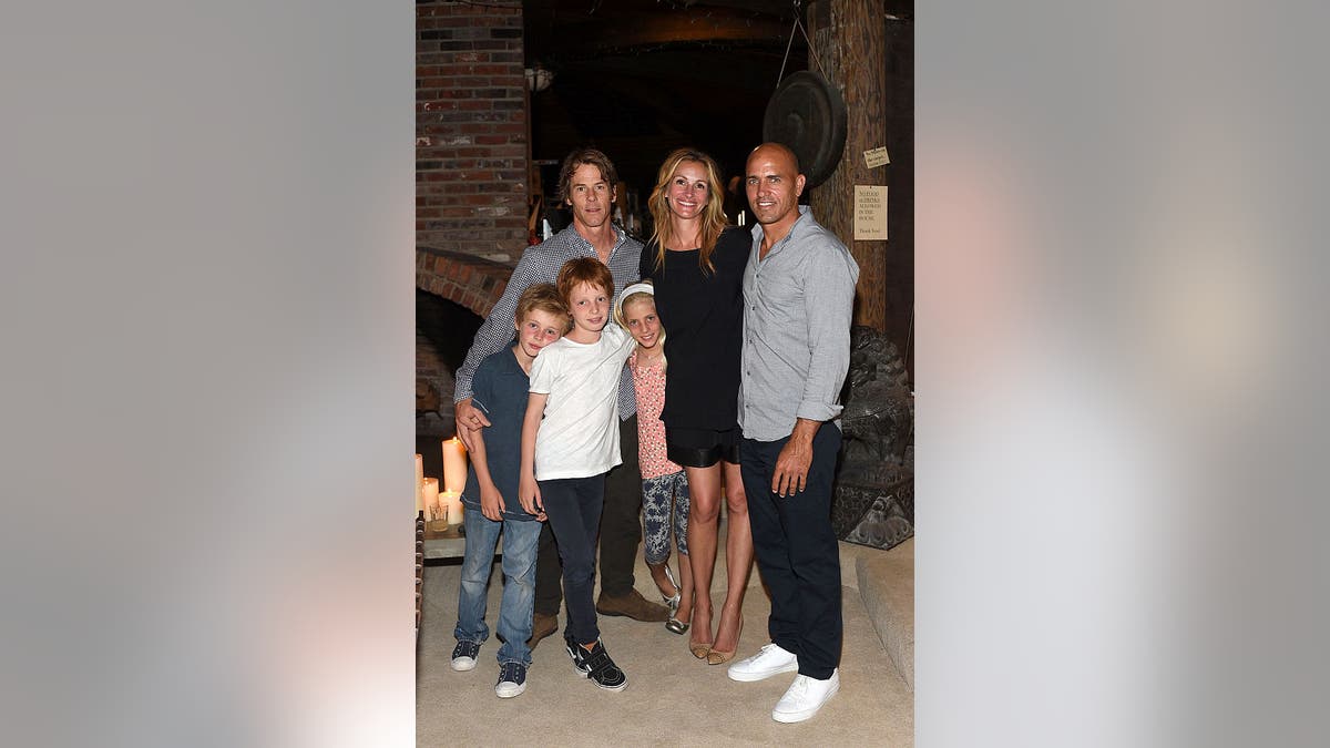 Julia Roberts, Danny Moder and their three kids pose alongside Kelly Slater in 2012