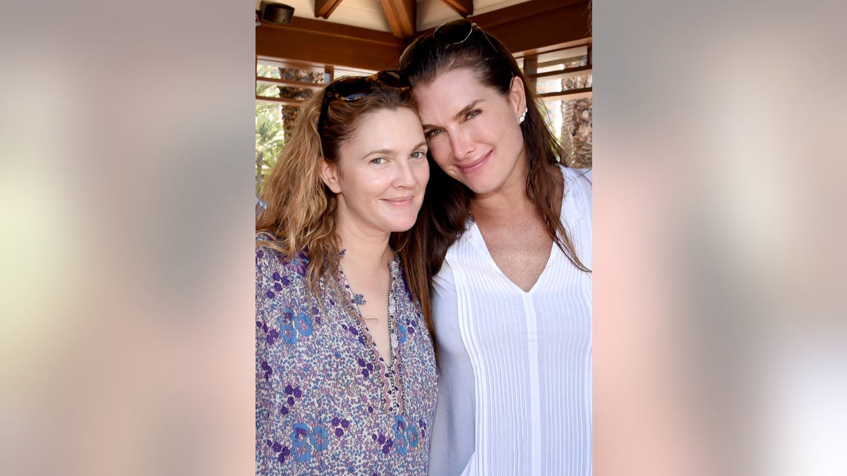 Drew Barrymore in a printed top and Brooke Shields in white smile for a photo together in The Bahamas