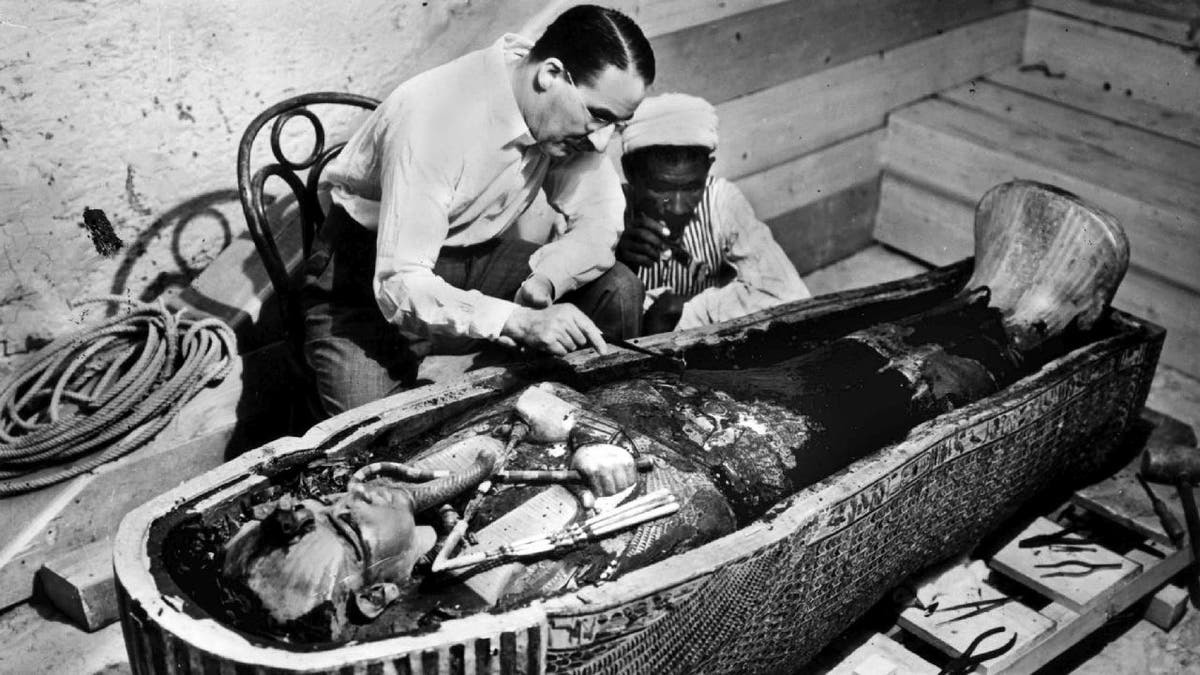 Howard Carter examines King Tut coffin