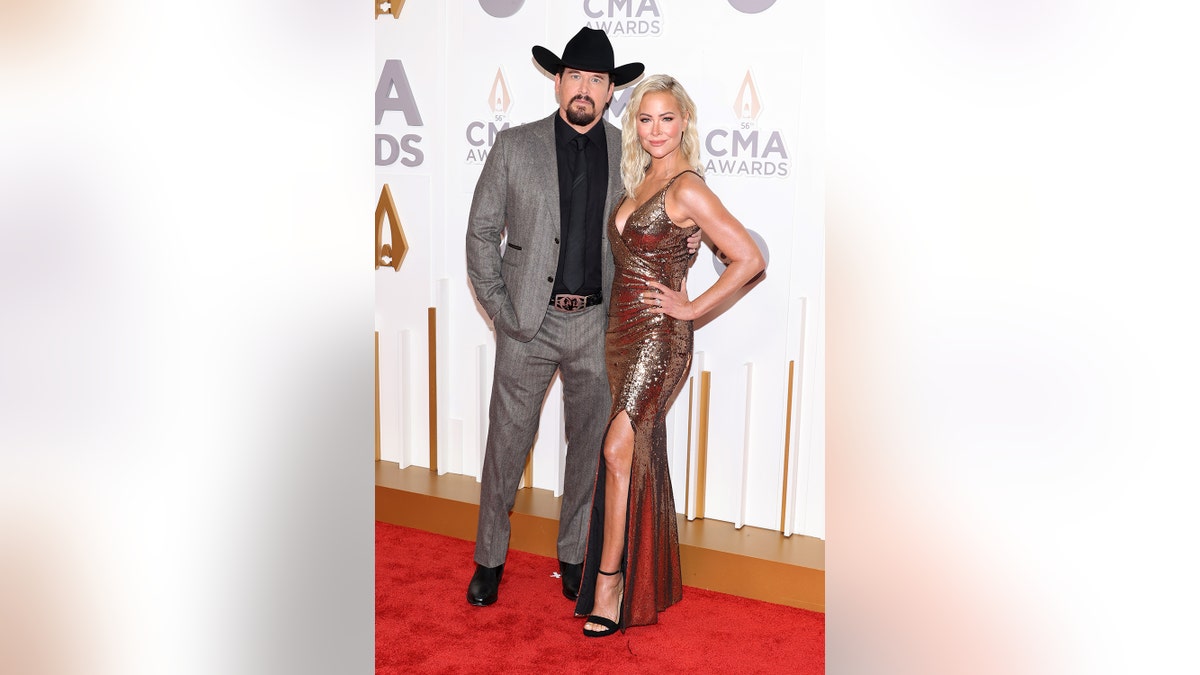 Cole Hauser and his wife on the red carpet for the CMA Awards