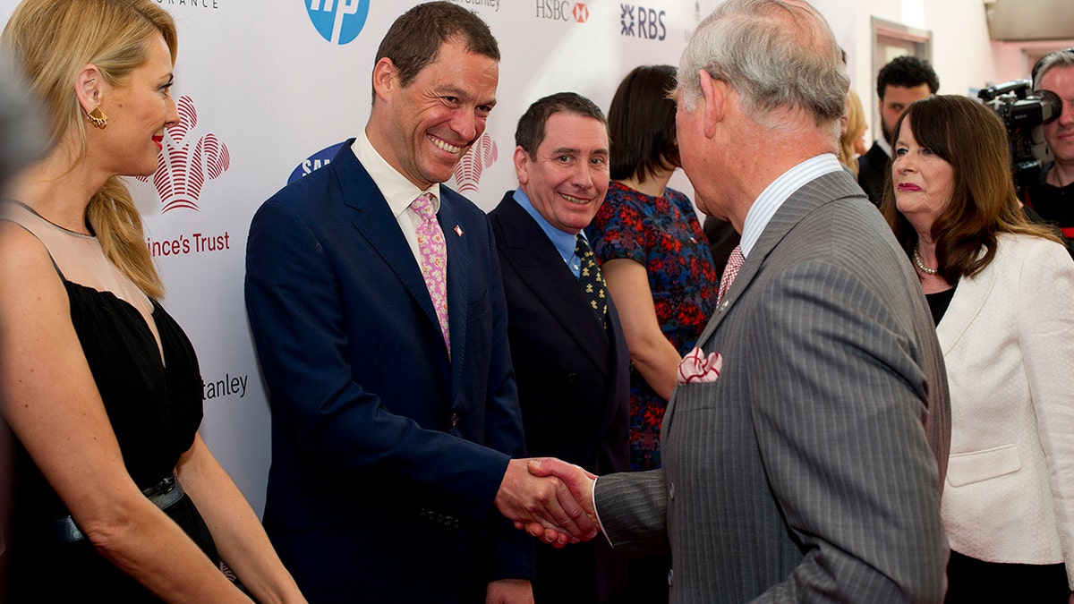 Dominic West shakes King Charles III's hand
