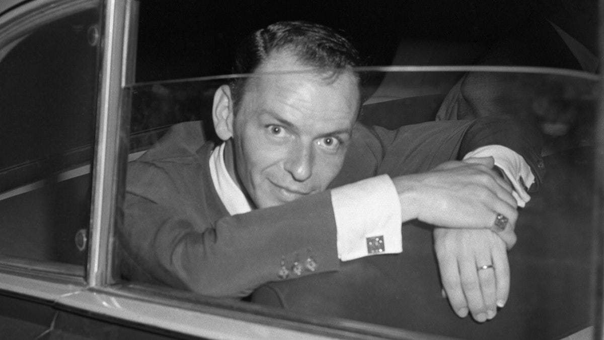 Frank Sinatra staring into a press camera