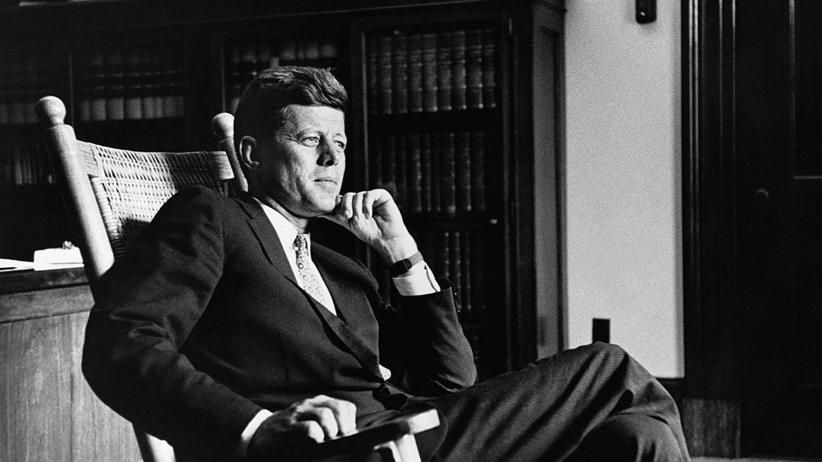 John F. Kennedy sitting on a chair