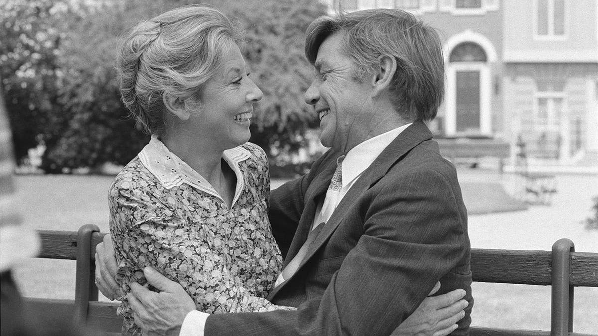 Michael Learned and Ralph Waite embracing each other