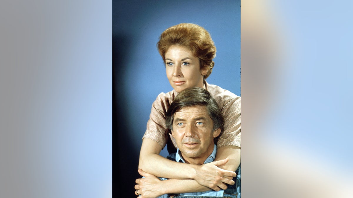 Michael Learned hugging Ralph Waite while filming The Waltons