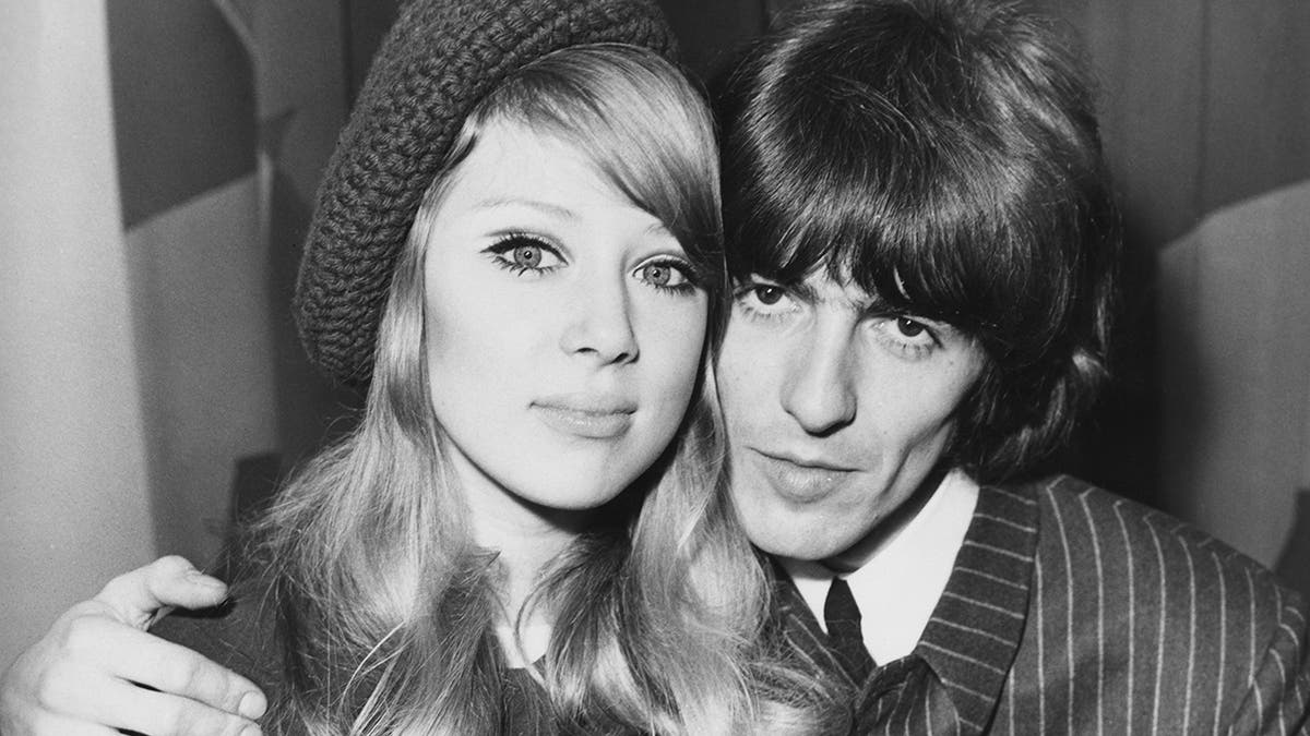 George Harrison and Pattie Boyd embrace at a press reception.
