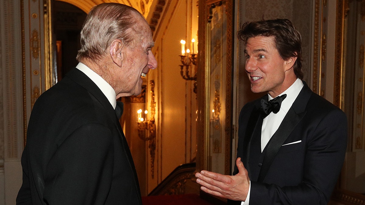 Prince Philip and Tom Cruise chatting during dinner