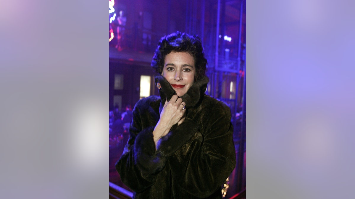 Sean Young poses in a coat during an after party