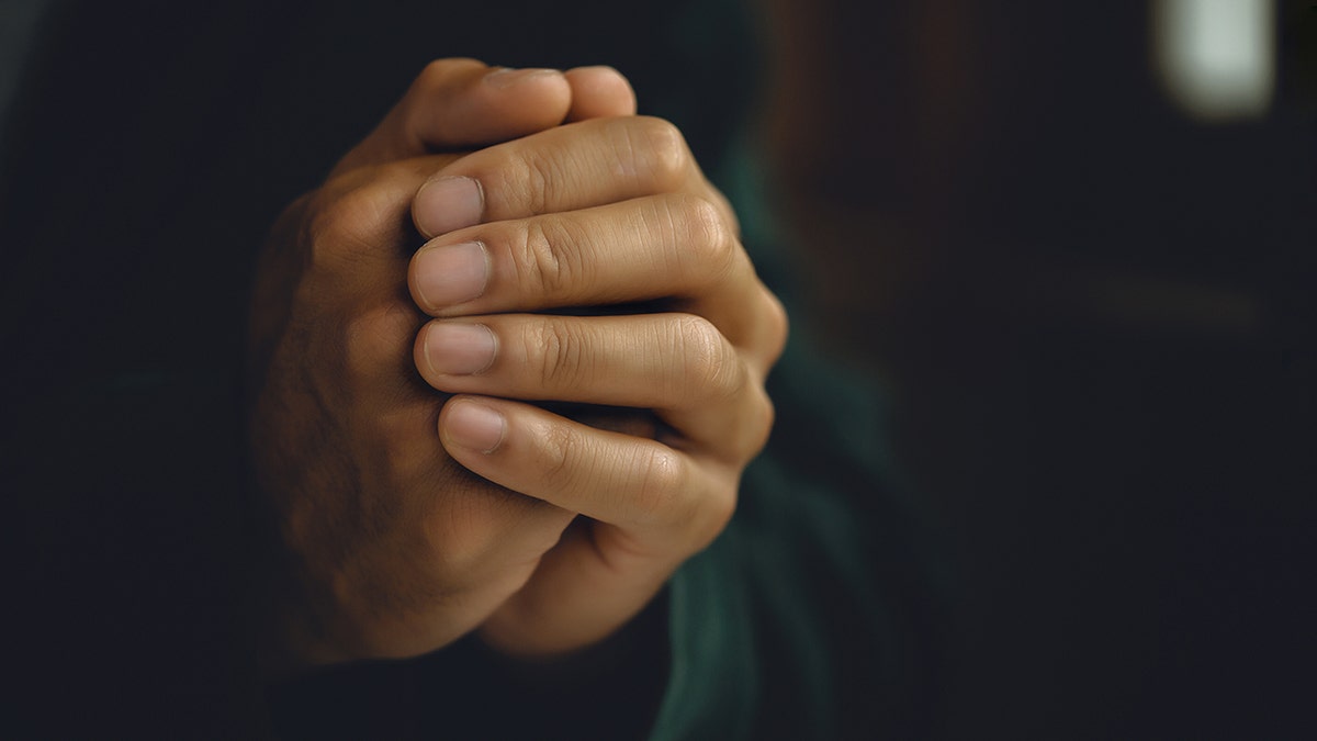 Man with hands in prayer