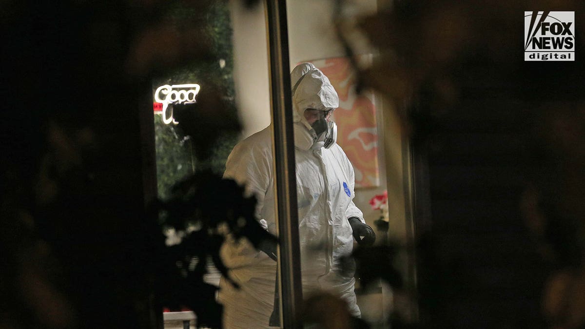 External through the window of an investigator wearing a hazmat suit