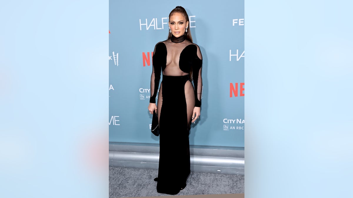 Jennifer Lopez poses in see-through black dress on red carpet at documentary premiere