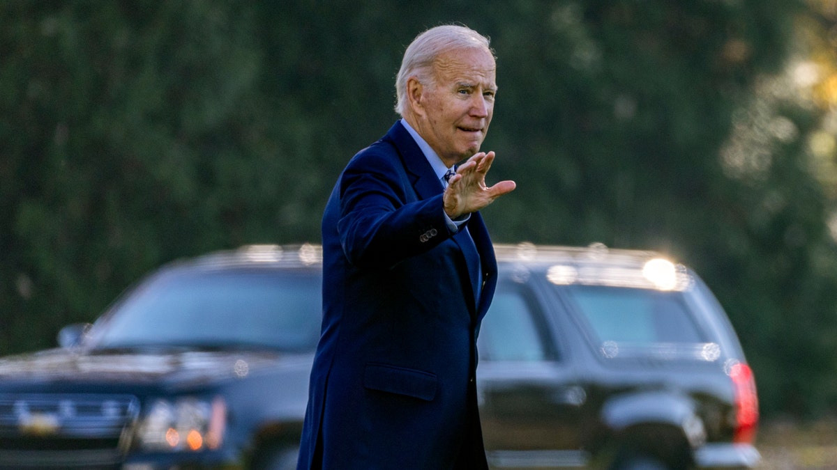 President Joe Biden waves as he prepares to depart on Marine One.