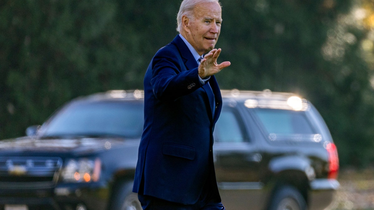 President Joe Biden waves as he prepares to depart on Marine One.