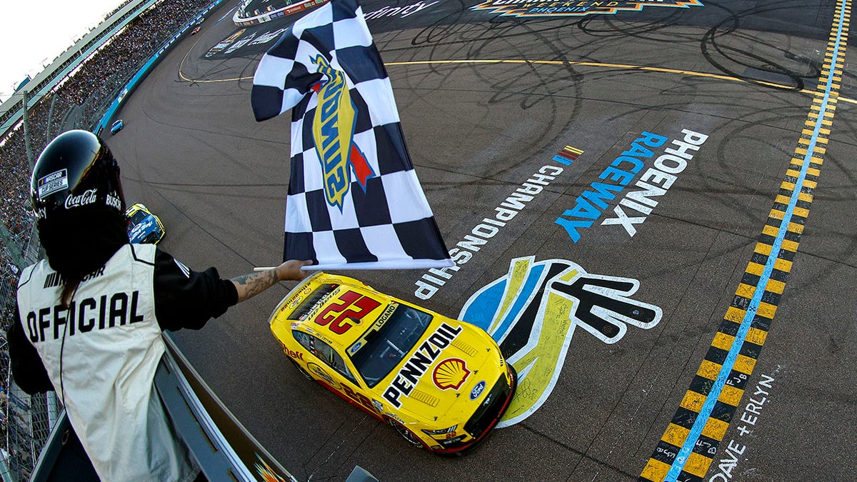 Joey Logano crosses the line as the champ