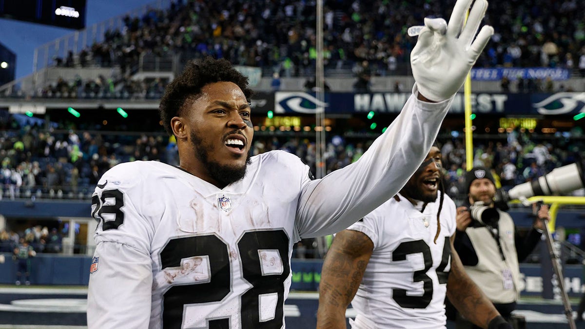 Josh Jacobs waves to the crowd