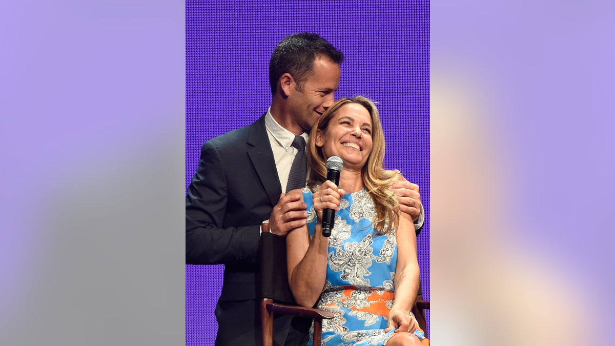 Kirk Cameron and Chelsea Noble show love on stage.