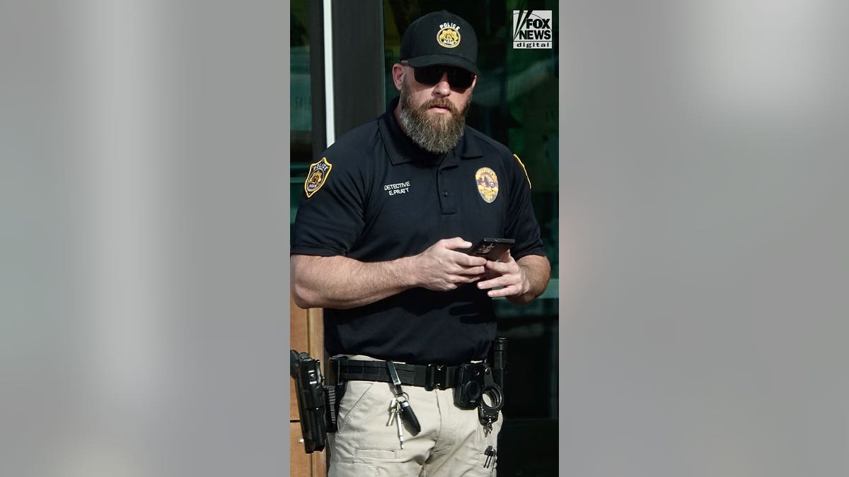 Police officer texts on his cell phone