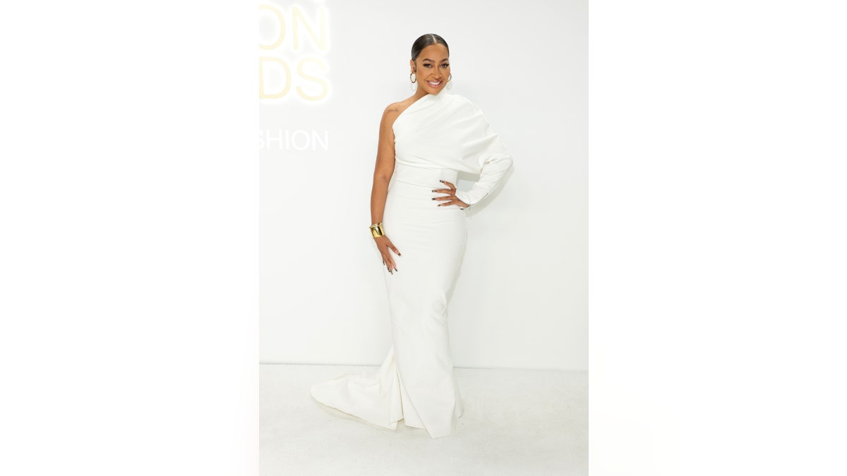 La La Anthony walks red carpet in white dress with one sleeve at CFDA Awards