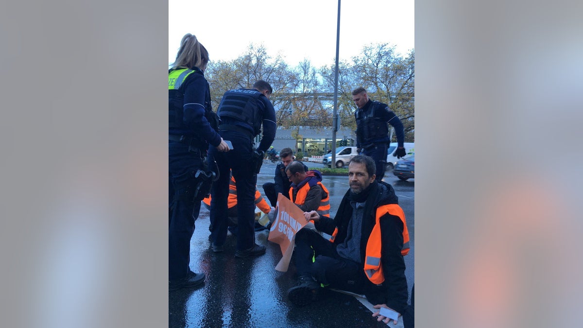 Climate protesters glue themselves to Cologne road