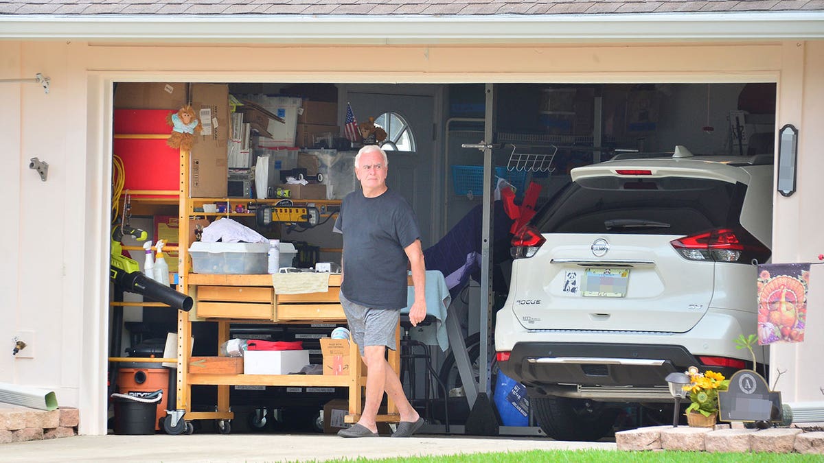 George Anthony standing in garage