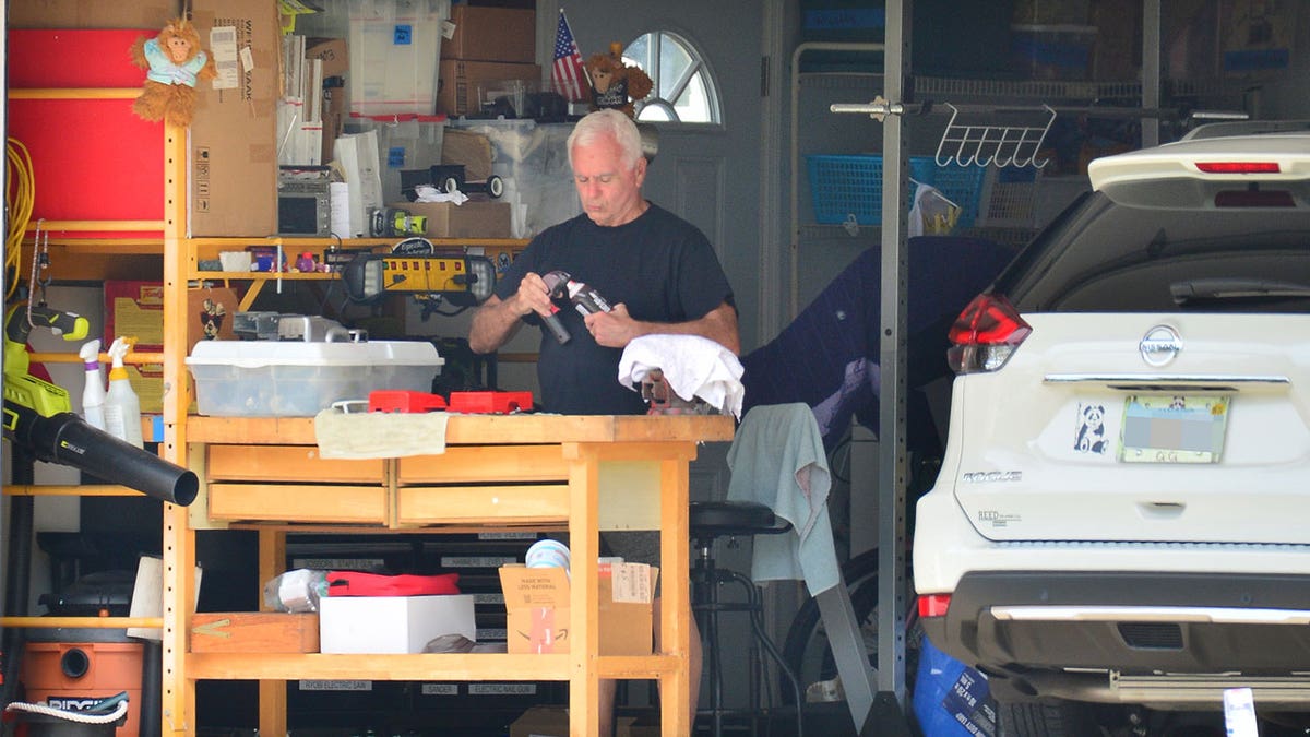 George Anthony working in garage