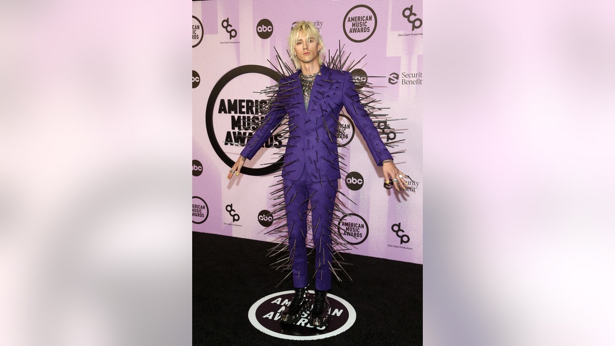 Machine Gun Kelly wears spikes on purple suit at AMAs in Los Angeles