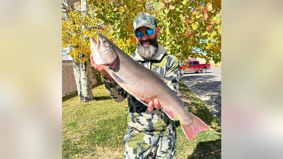 Matt Smiley poses with his record-breaking brook trout in Colorado