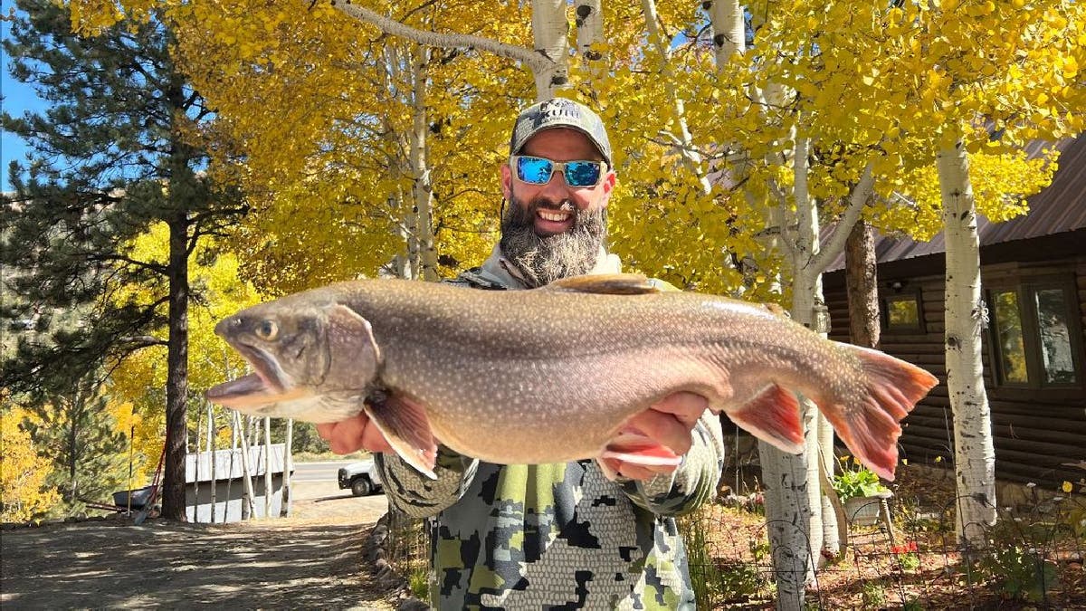 Matt Smiley holds up his record-breaking brook trout
